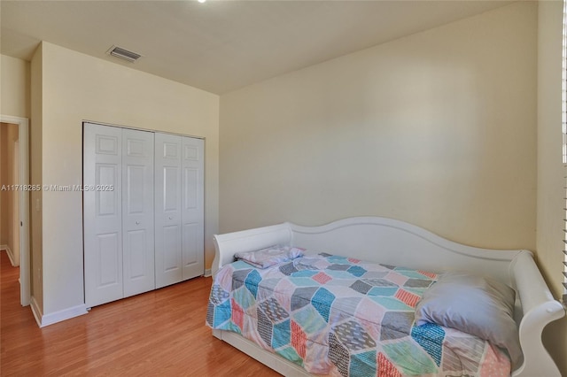 bedroom featuring hardwood / wood-style flooring and a closet