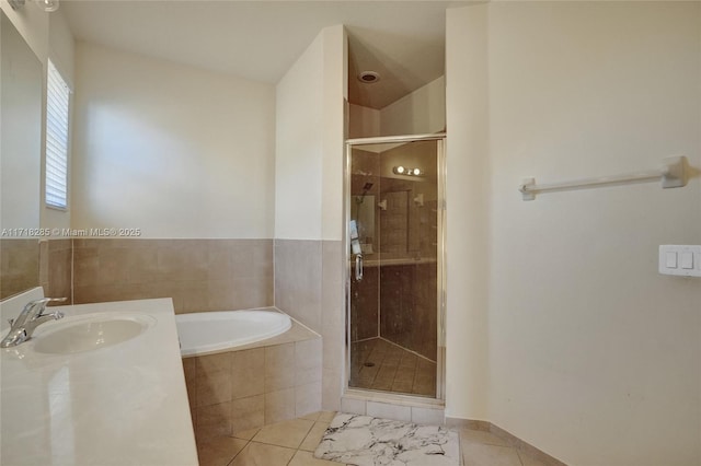 bathroom with vanity, tile patterned floors, and shower with separate bathtub