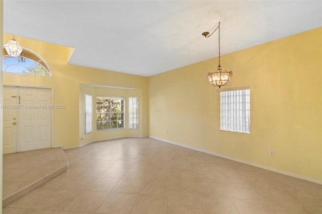 tiled foyer featuring an inviting chandelier and a wealth of natural light