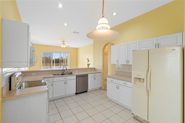 kitchen with sink, white cabinetry, tasteful backsplash, decorative light fixtures, and appliances with stainless steel finishes