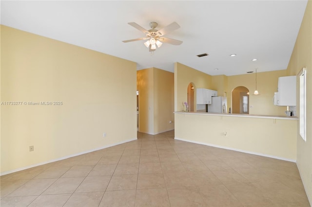 unfurnished living room with light tile patterned floors and ceiling fan