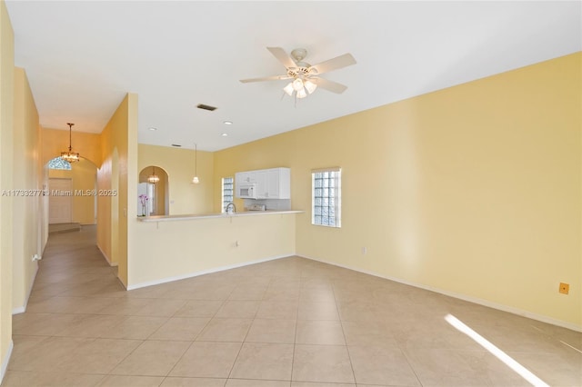 tiled spare room with ceiling fan