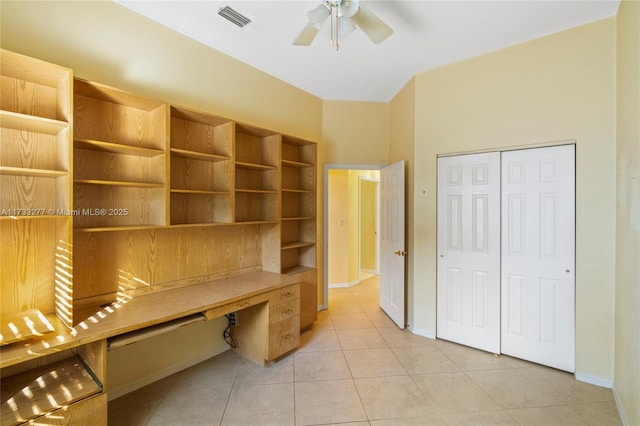 unfurnished office featuring light tile patterned floors and ceiling fan