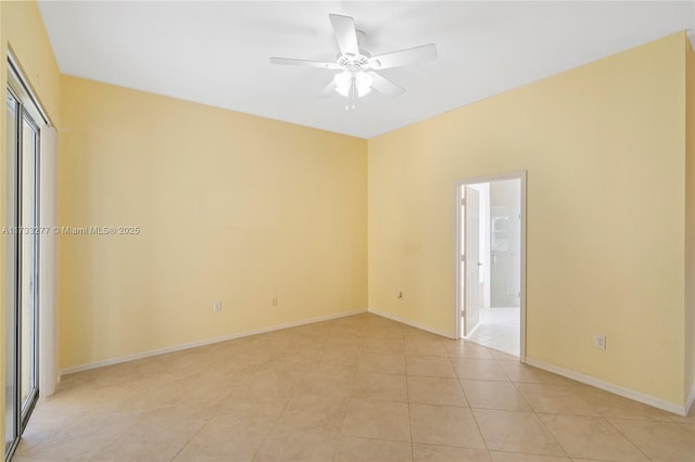 tiled spare room with ceiling fan