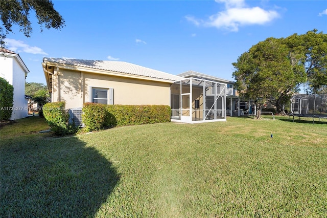 rear view of house featuring a yard