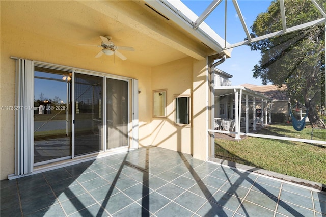 unfurnished sunroom featuring ceiling fan and a skylight