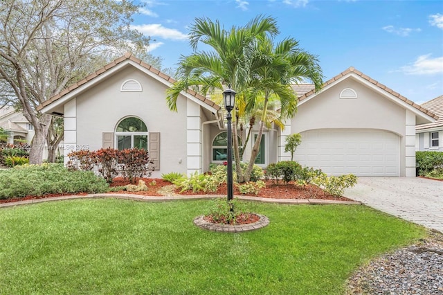 view of front facade featuring a garage and a front lawn