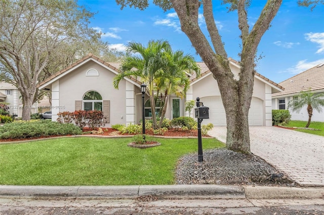 view of front of house featuring a garage and a front lawn