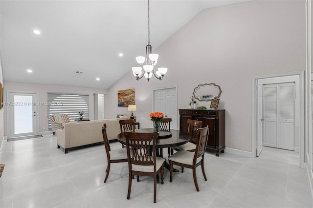 dining space with light tile patterned floors, high vaulted ceiling, and a chandelier