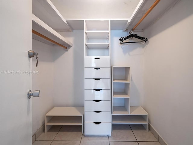 spacious closet with light tile patterned flooring