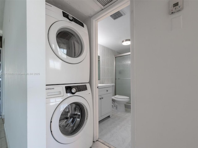 laundry area with stacked washer / dryer