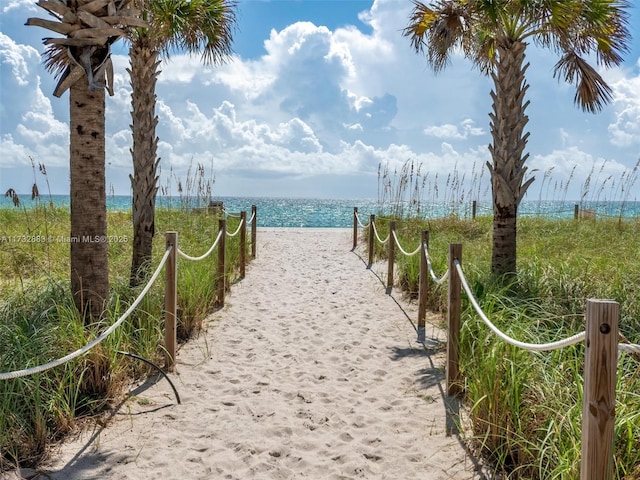 surrounding community with a view of the beach and a water view