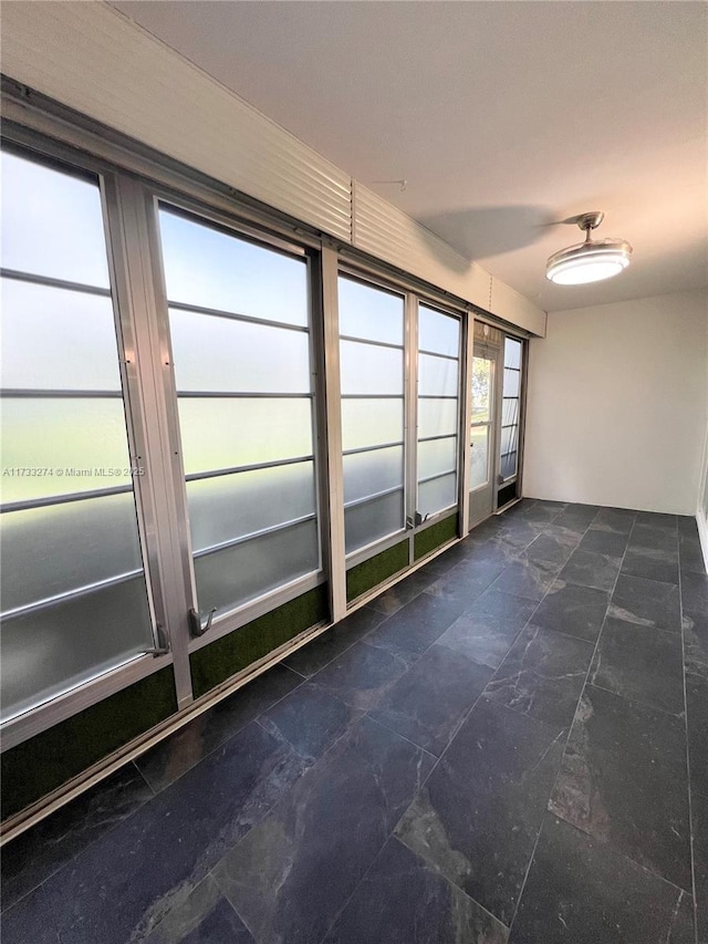 unfurnished room featuring stone finish flooring