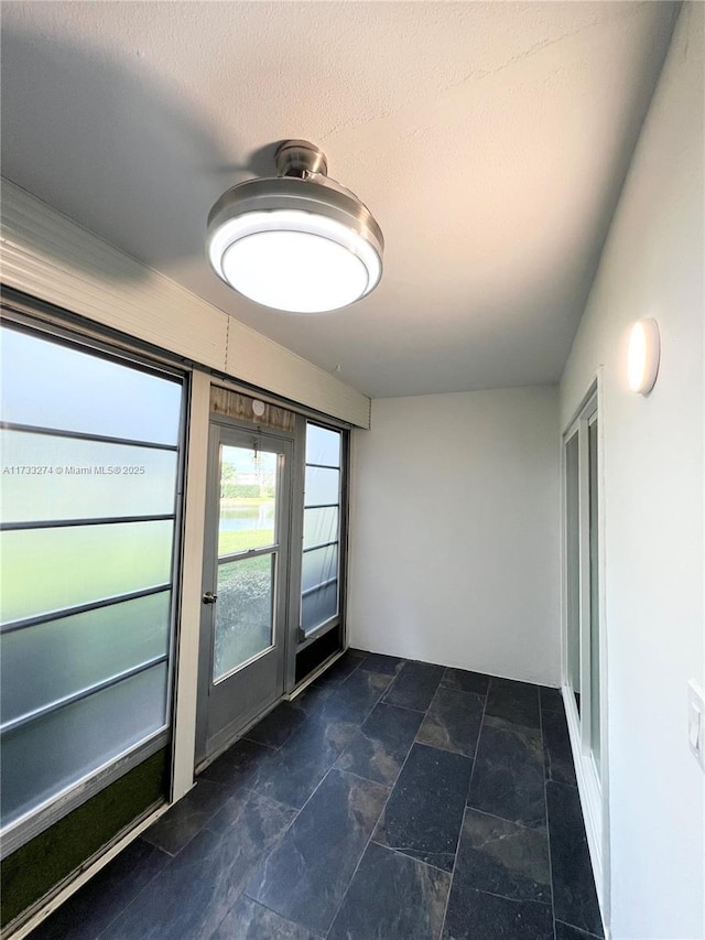 spare room with a textured ceiling