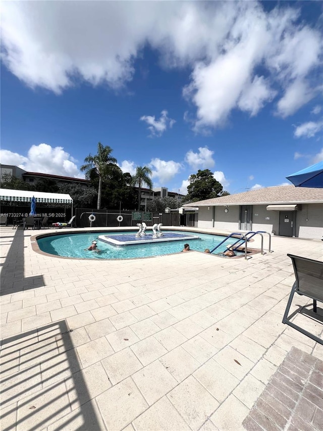 pool with fence and a patio area
