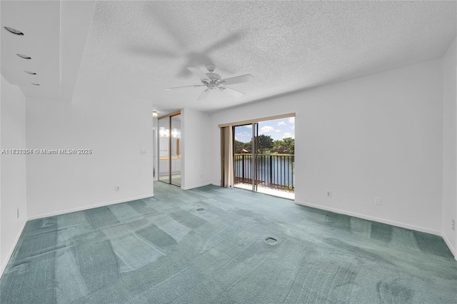 unfurnished room with ceiling fan, a textured ceiling, and carpet flooring