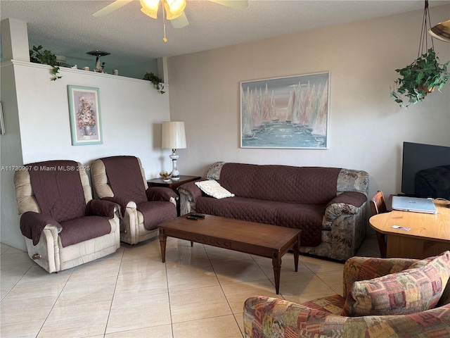 tiled living room featuring ceiling fan and a textured ceiling