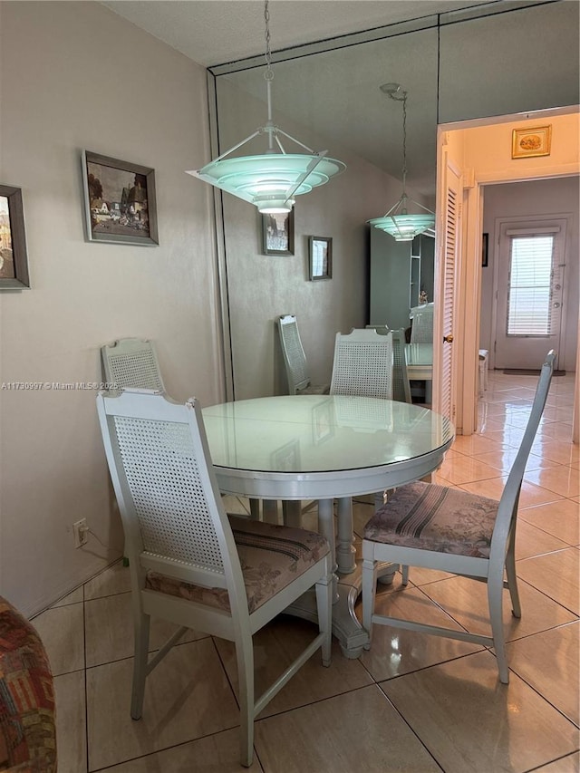 dining space featuring light tile patterned floors