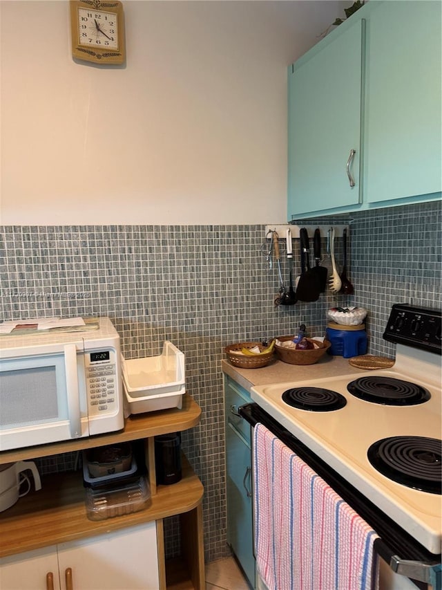 kitchen with range with electric stovetop and tile walls