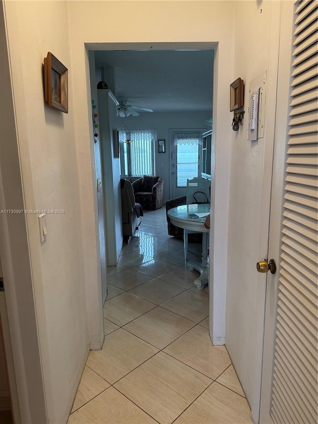 corridor featuring light tile patterned flooring