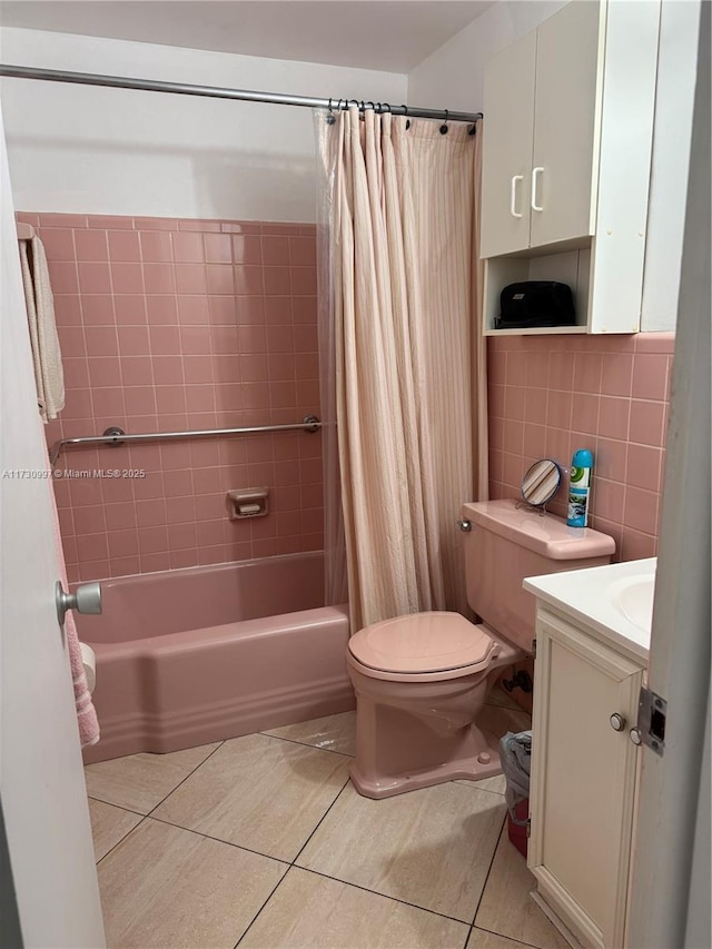 full bathroom featuring shower / tub combo with curtain, vanity, decorative backsplash, tile patterned floors, and toilet