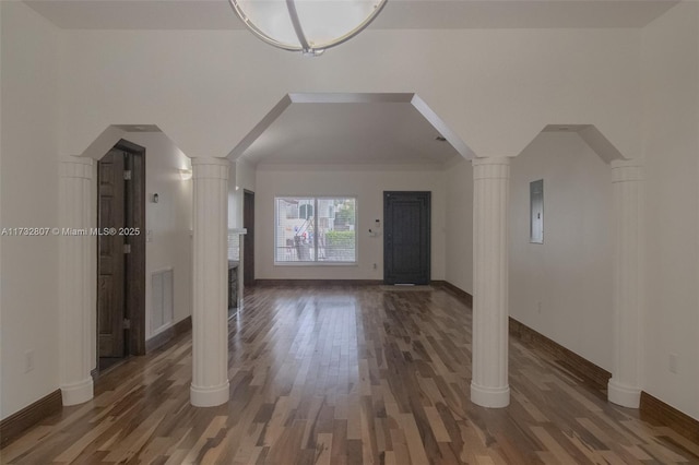 foyer with dark wood-type flooring, arched walkways, visible vents, and ornate columns