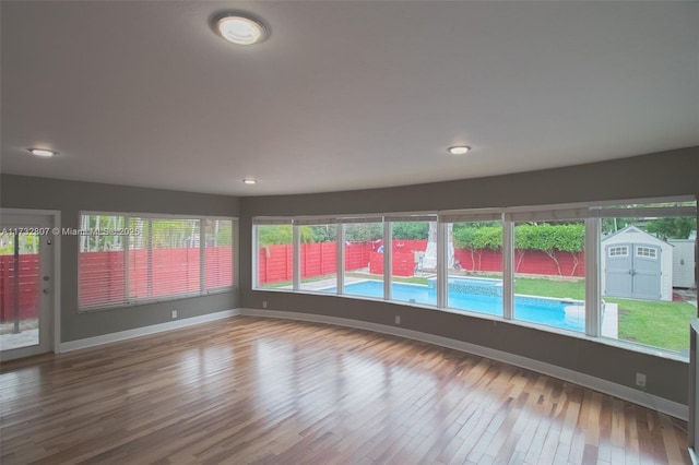 empty room featuring baseboards and wood finished floors