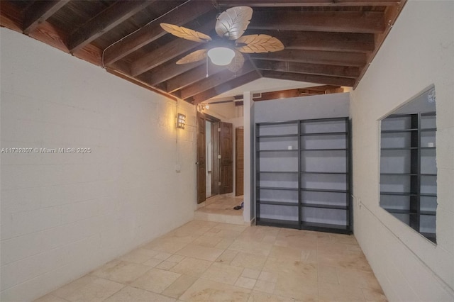 interior space featuring lofted ceiling with beams and a ceiling fan