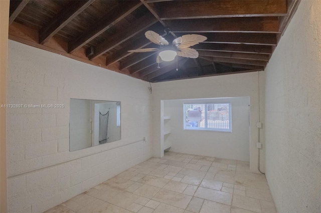 empty room with lofted ceiling with beams and a ceiling fan