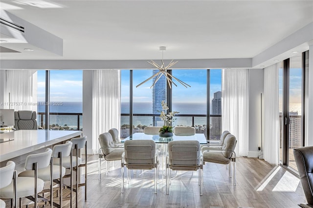 dining room with a water view and a notable chandelier