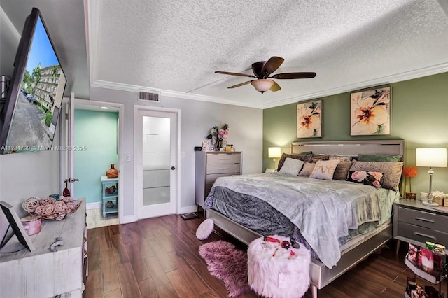 bedroom featuring a textured ceiling, ornamental molding, dark hardwood / wood-style floors, and ceiling fan