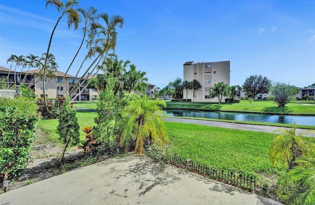 view of community featuring a water view and a yard