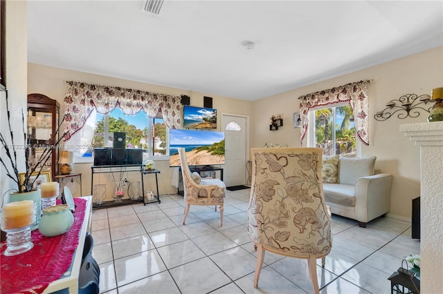 living room featuring visible vents and light tile patterned flooring