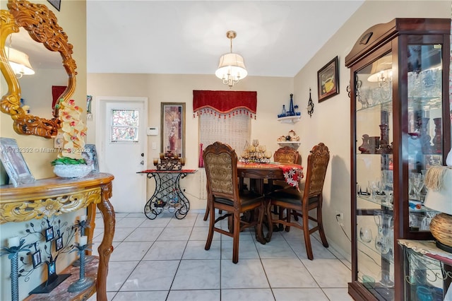 dining area with light tile patterned floors and a notable chandelier