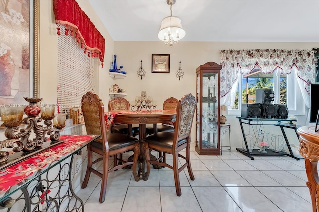 dining room with light tile patterned floors and a chandelier