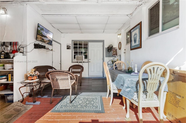 dining area with a paneled ceiling