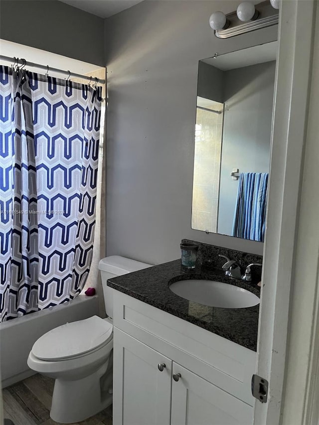 full bathroom featuring toilet, vanity, shower / bathtub combination with curtain, and hardwood / wood-style flooring