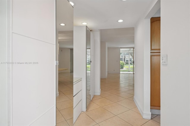 hall featuring light tile patterned floors