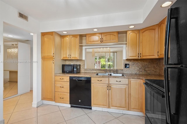 kitchen featuring light brown cabinetry, sink, light tile patterned floors, and black appliances