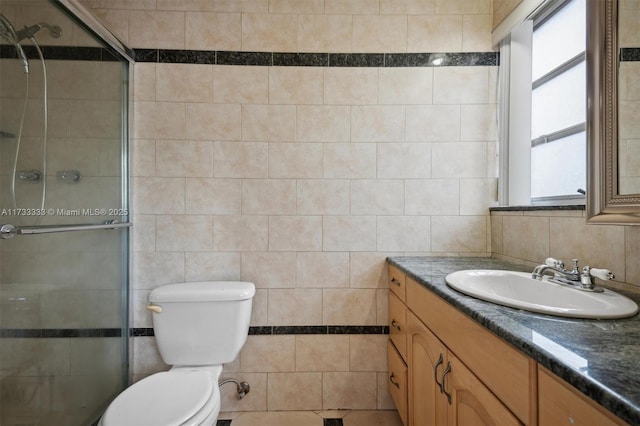 bathroom with a wealth of natural light, a shower with shower door, tile walls, and toilet