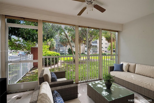 sunroom / solarium featuring ceiling fan