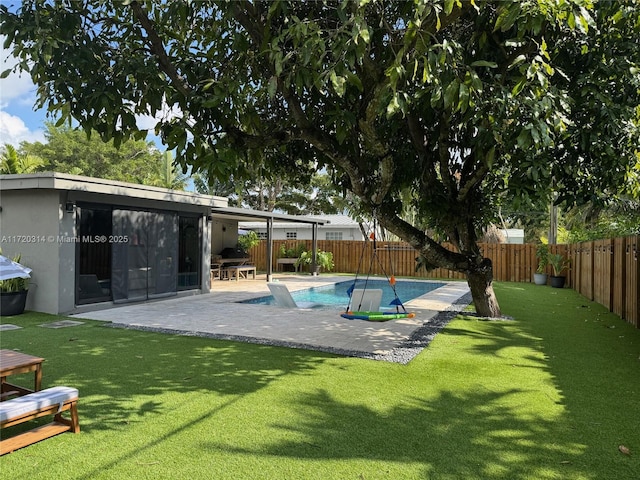 view of pool featuring a patio area and a lawn