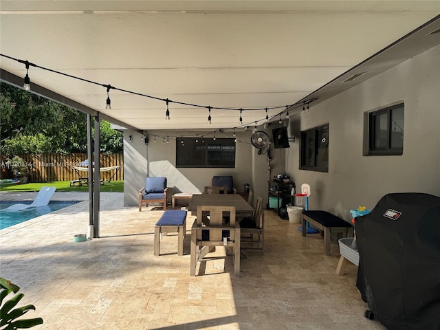 view of patio / terrace with a swimming pool, electric panel, and grilling area