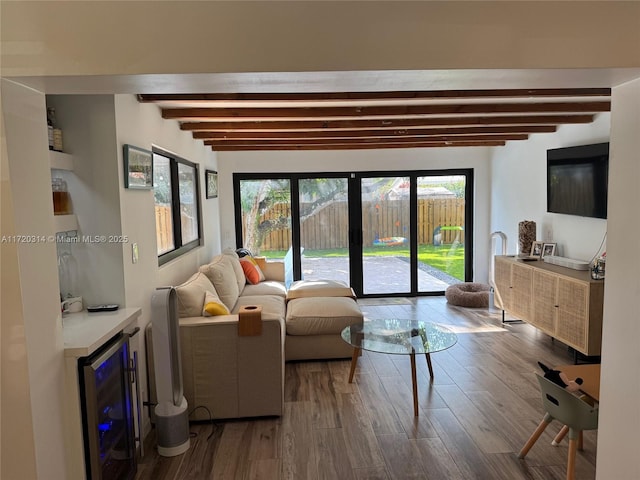 living room featuring wine cooler, hardwood / wood-style floors, and beam ceiling