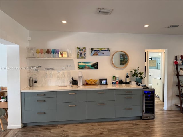 bar with dark wood-type flooring, decorative backsplash, and wine cooler