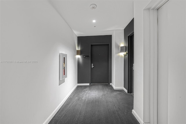 corridor featuring dark carpet