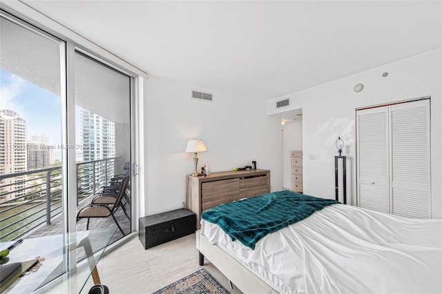 bedroom with floor to ceiling windows, access to exterior, and a closet