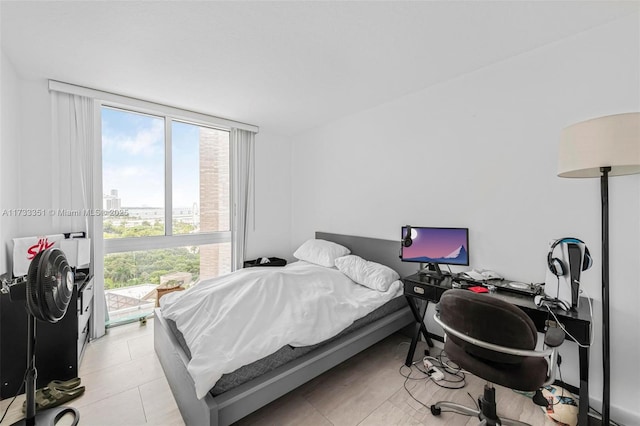 tiled bedroom featuring floor to ceiling windows