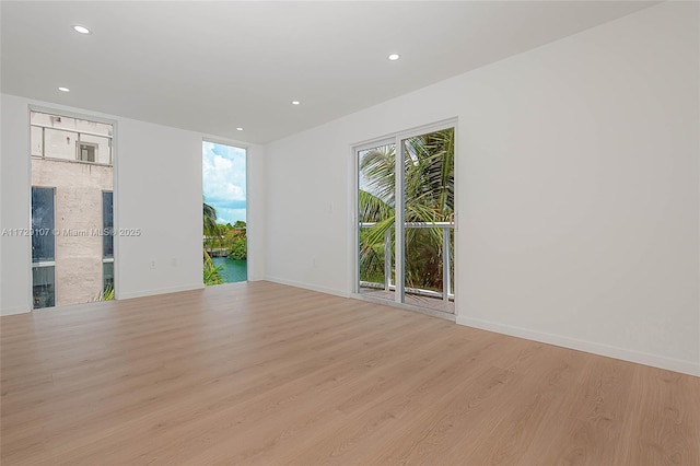 spare room with light hardwood / wood-style floors