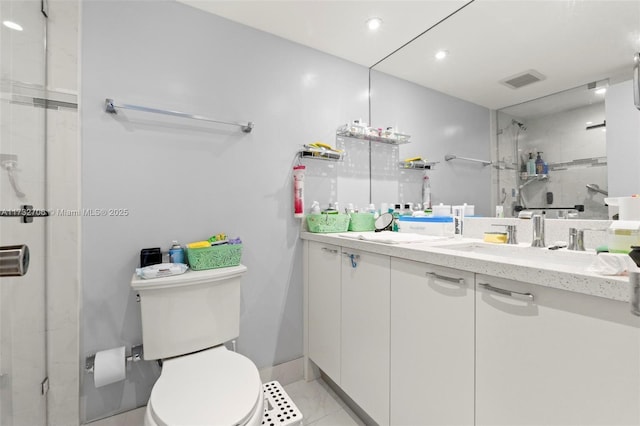 bathroom featuring vanity, a shower, tile patterned floors, and toilet